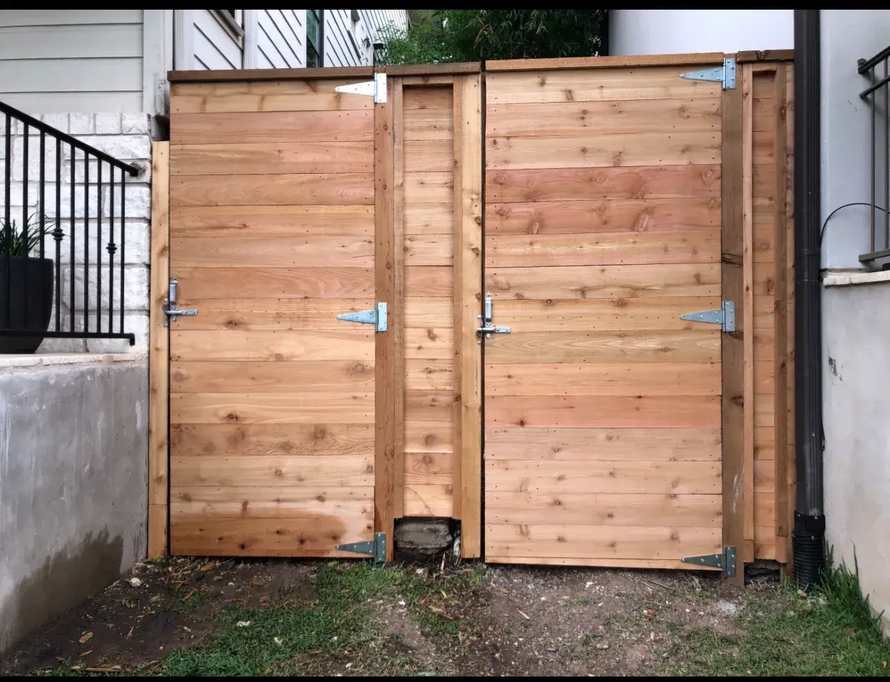 Custom cedar double swing gate with decorative hinges