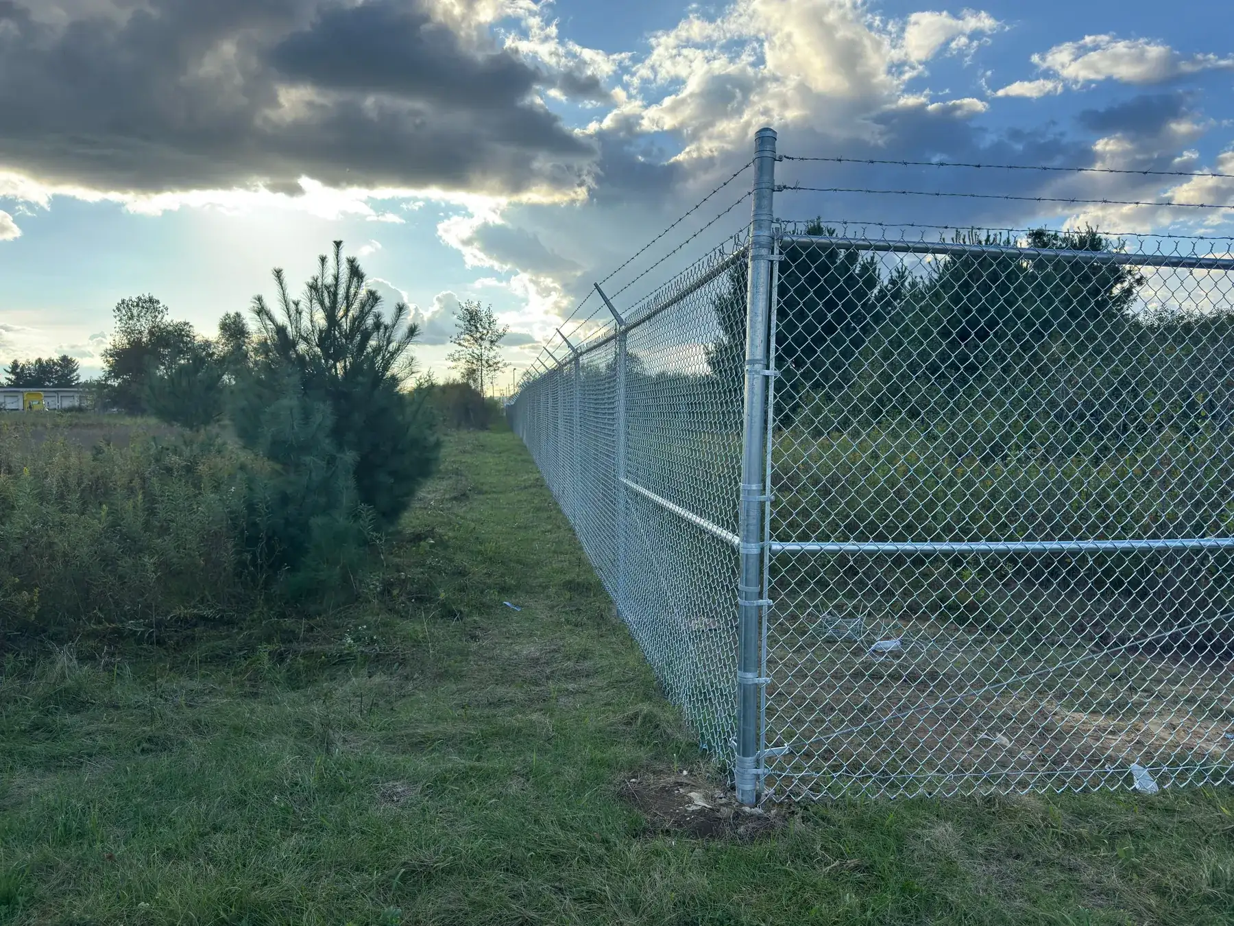 Steel perimeter fence and gate installed by SecureBound